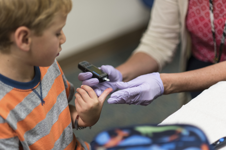 Falmouth Elementary first grader Owen Pollard, 6, has his blood sugar carbohydrate levels checked in Falmouth.
