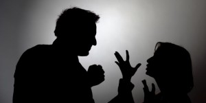 Man beating woman, silhouette
